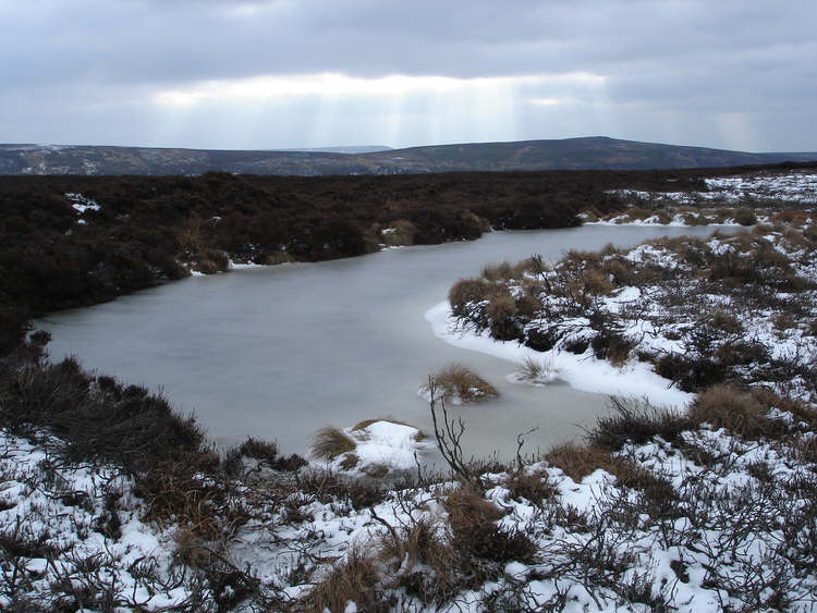 A frozen pond on Clough Gill Top 