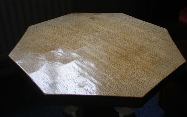 The top of a hexagonal Robert Thompson table, showing the Adze marks that gives the furniture its distinctive appearance. 