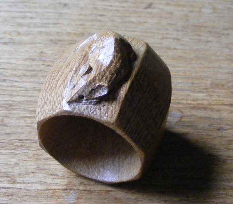 This picture shows the mouse on top of a Robert Thompson napkin ring. Each wood carver produces a different mouse - here we see a slightly curved mouse. 