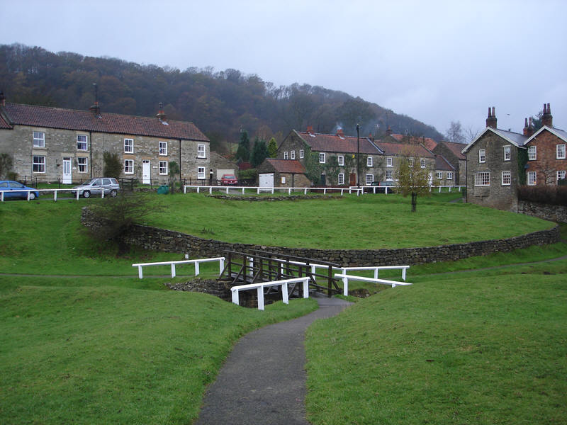 The green at Hutton-le-Hole, looking north west across a neat wooden bridge